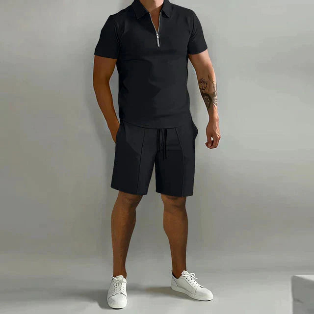 Man wearing black short-sleeve zip polo and tailored shorts set with white sneakers