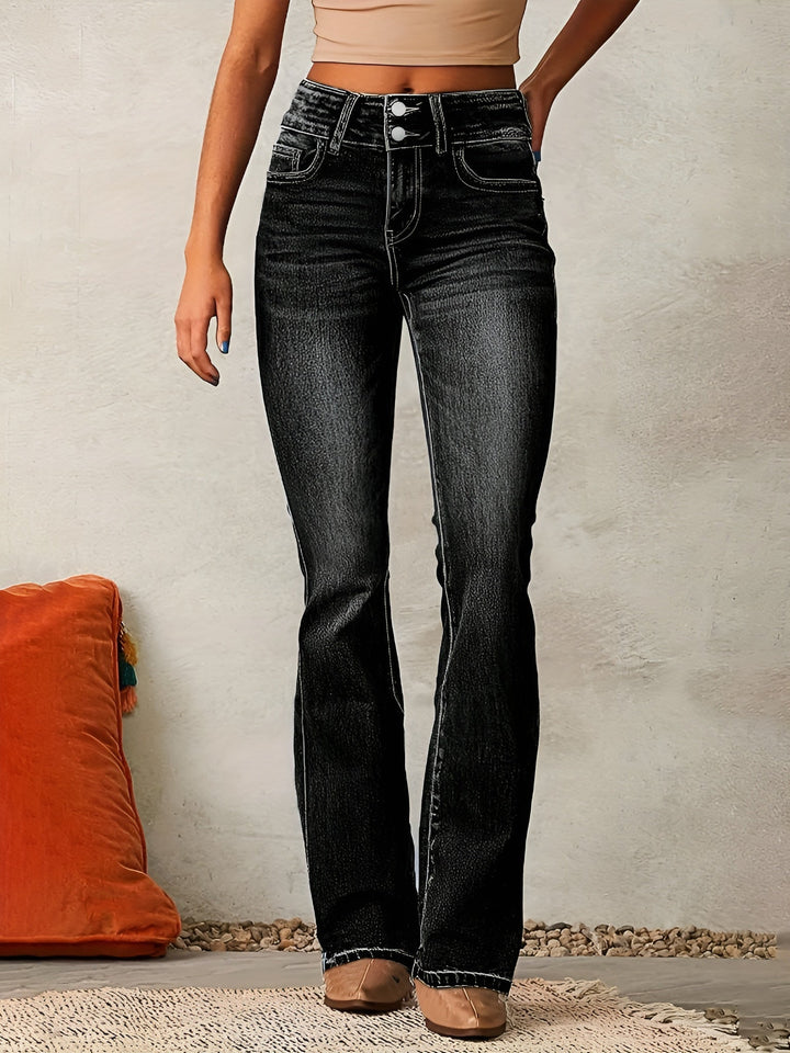 Woman wearing black flared jeans paired with neutral top