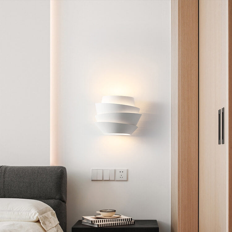 Warm ambiance created by Scandinavian LED wall lamp in a bedroom