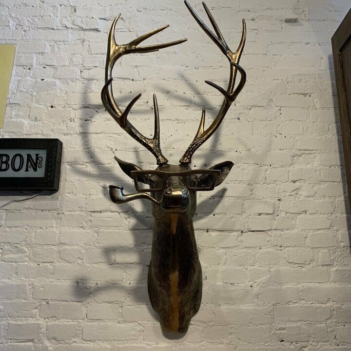 Resin animal sculpture mounted on a wall for unique and creative decorative wall art