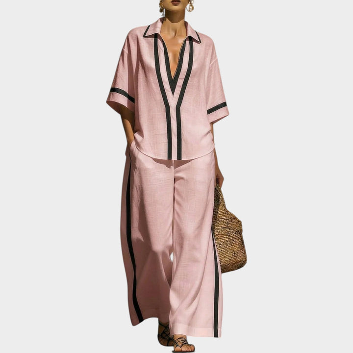 Model wearing a pink two-piece matching set featuring an oversized top and trousers