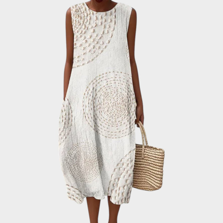 Woman wearing white sleeveless textured summer midi dress with woven bag