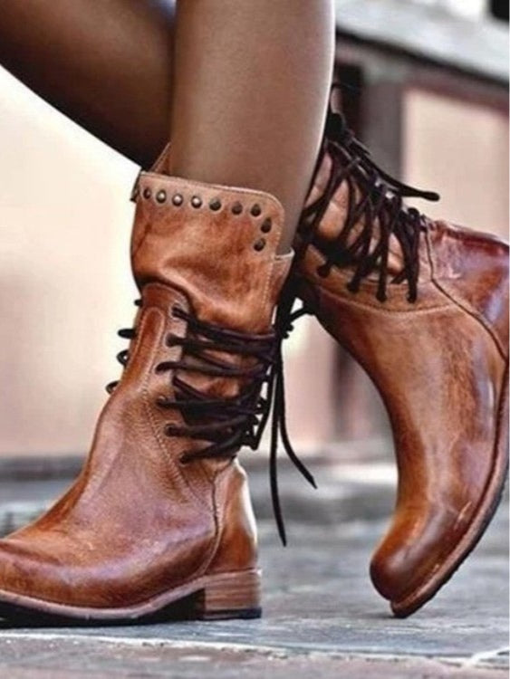 Women's brown retro rivet lace-up mid-calf boots showcased outdoors