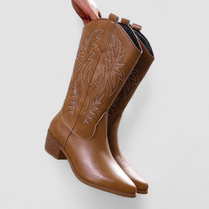 Brown classic style western cowboy boots held up