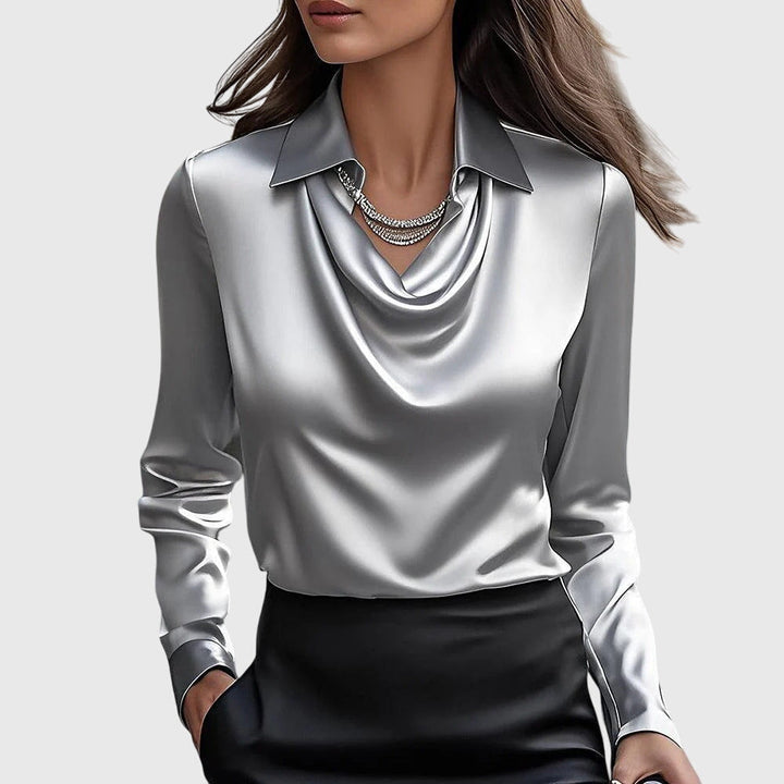Model wearing a silver elegant pleated neckline blouse paired with dark trousers