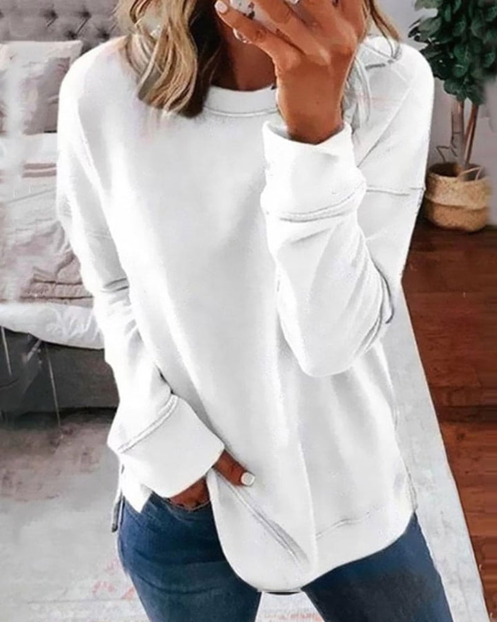 Woman wearing a white classic long sleeve sweatshirt