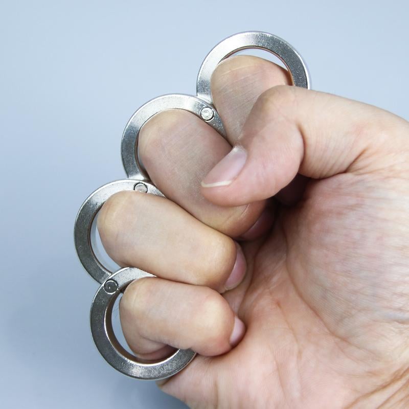 Close-up of a person holding the metal folding four-finger ring in hand