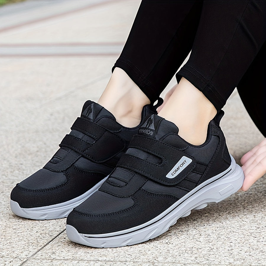 Close-up of black unisex walking shoes with Velcro straps