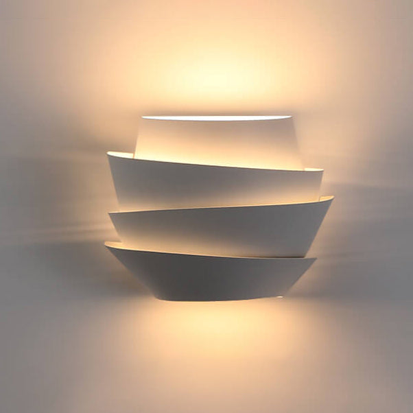 Front view of the modern iron wall lamp casting symmetrical up-and-down light beams.