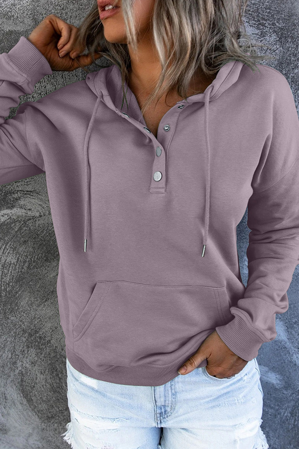 Close-up of green fabric on women's casual hoodie sweater