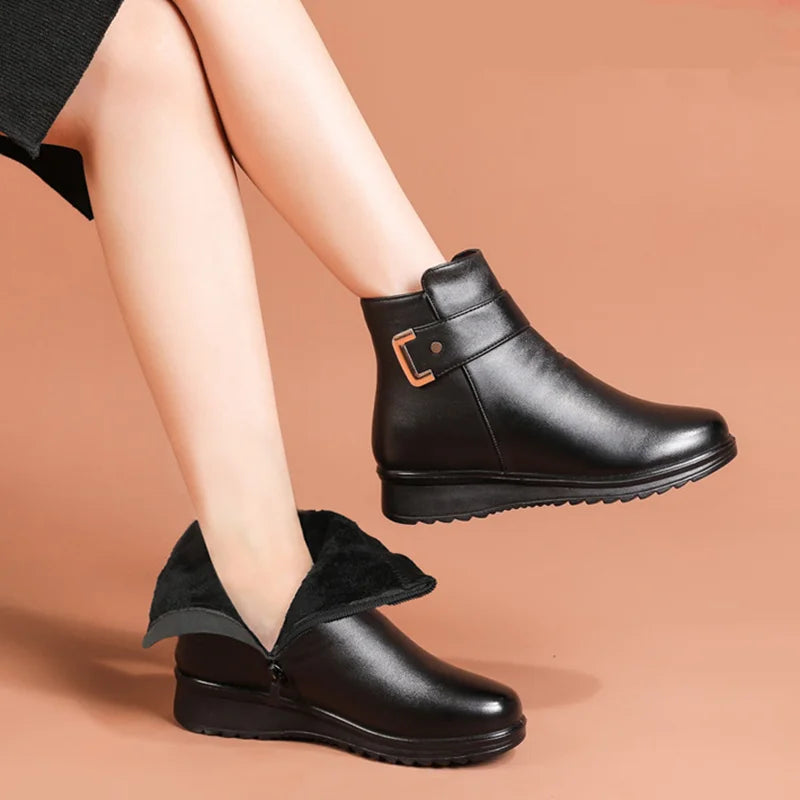 Close-up of women's black winter boots with soft lining and side buckle detail