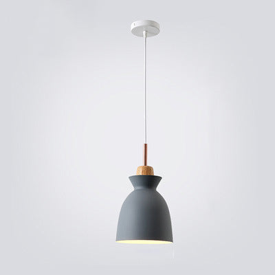 Nordic metal pendant light hanging over a modern dining room table