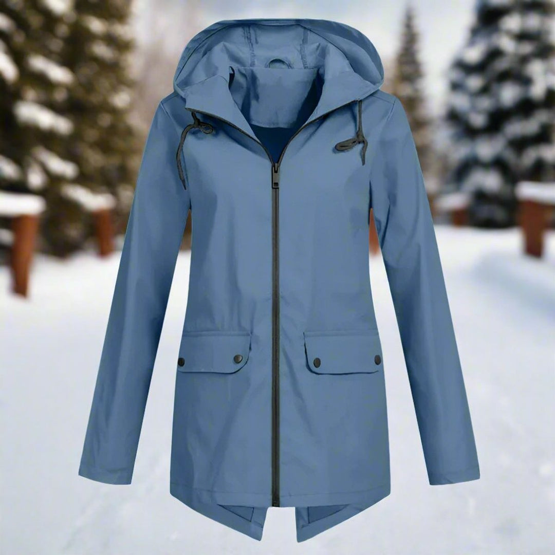 Model wearing women's hooded rain jacket outdoors in light drizzle