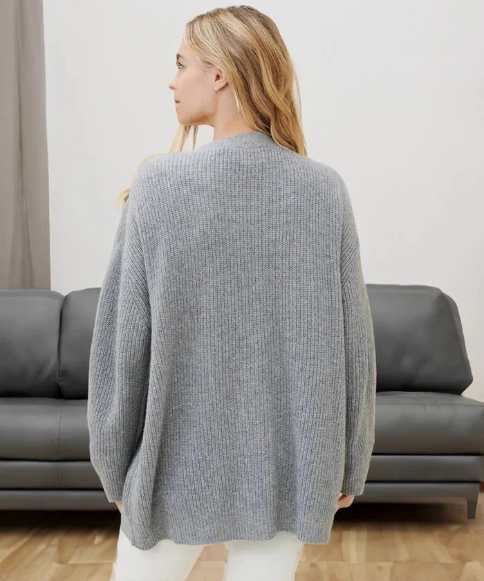 Cozy knit cardigan vest showcasing armhole and shoulder fit