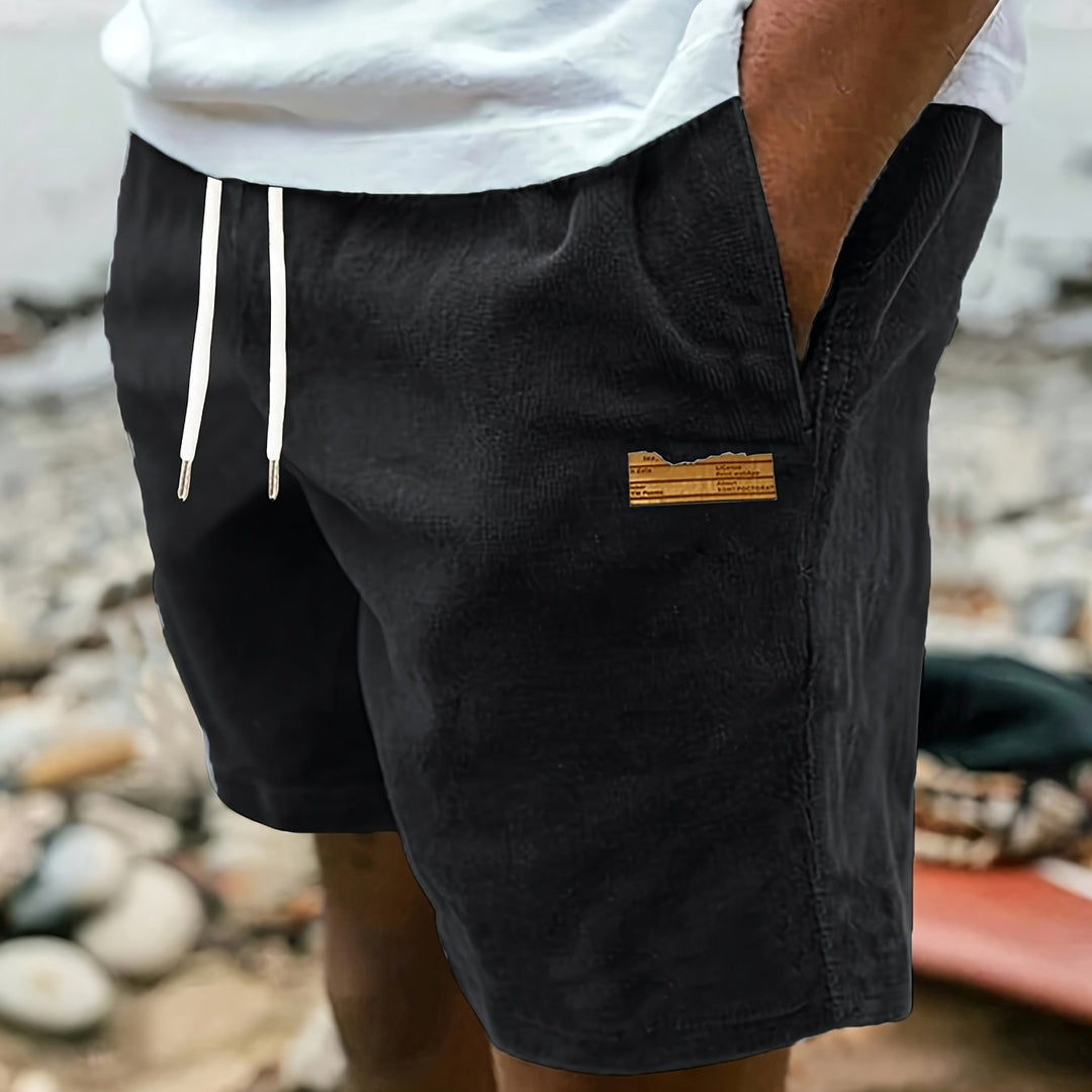 Folded stack of mens drawstring shorts in various colors