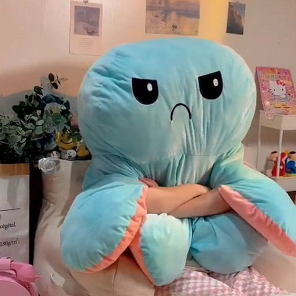 Blue plush octopus toy sitting indoors