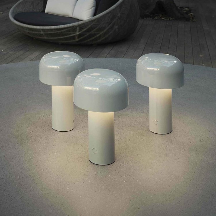 Cordless led desk lamp casting warm atmospheric illumination across a cozy room