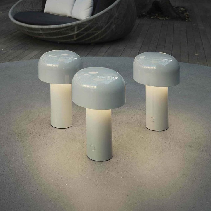 Cordless led desk lamp casting warm atmospheric illumination across a cozy room