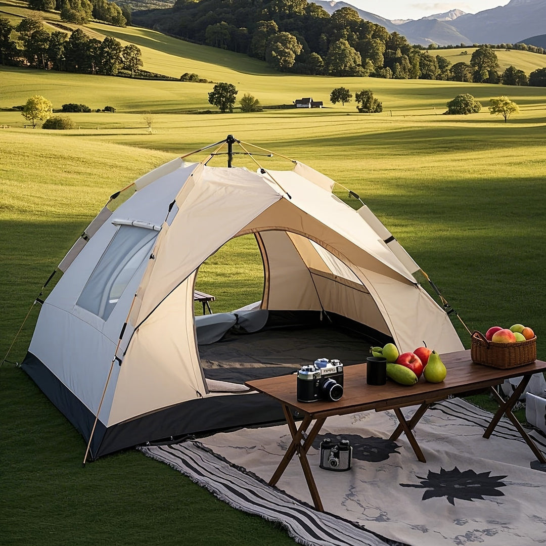Automatic camping tent set up on a green field with mountains in the background