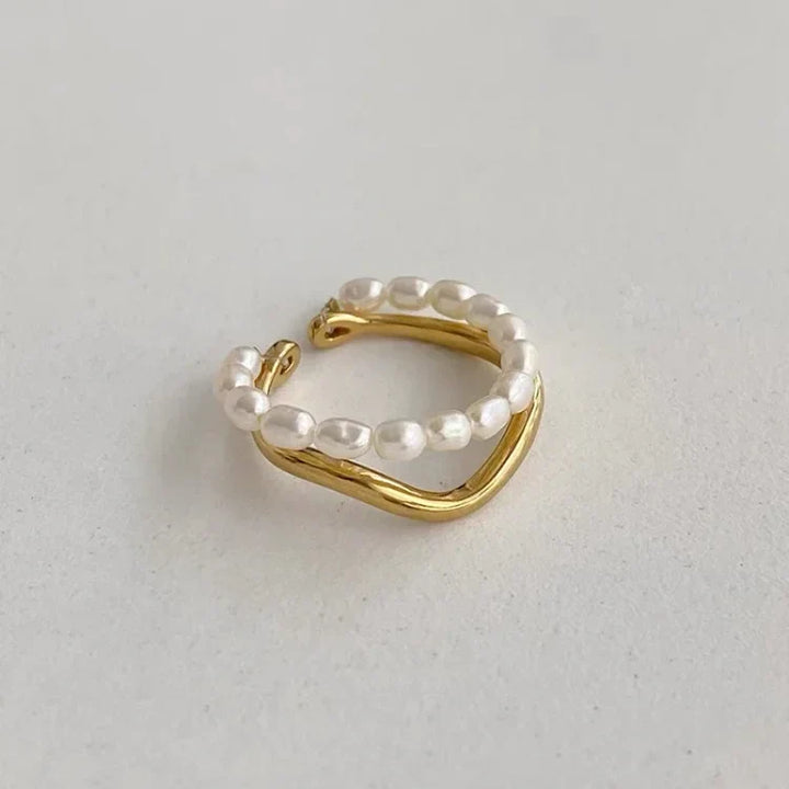 Close-up view of the double-layered gold pearl ring showing dual bands