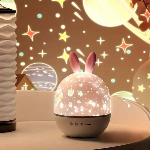 Rabbit style StarGlow projector casting a starry sky projection on a table