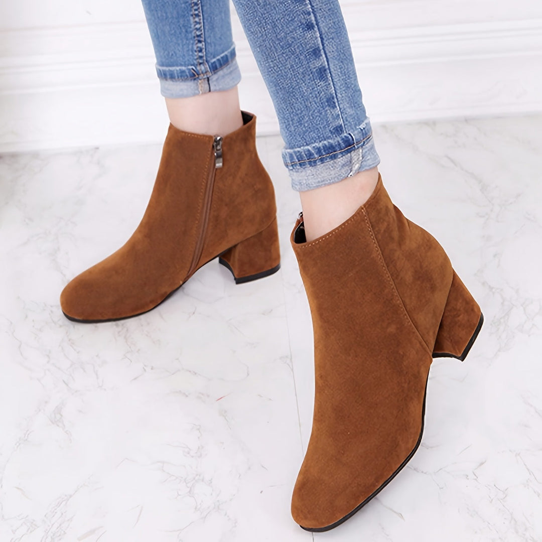 Side profile of women's black chelsea ankle boots with block heel