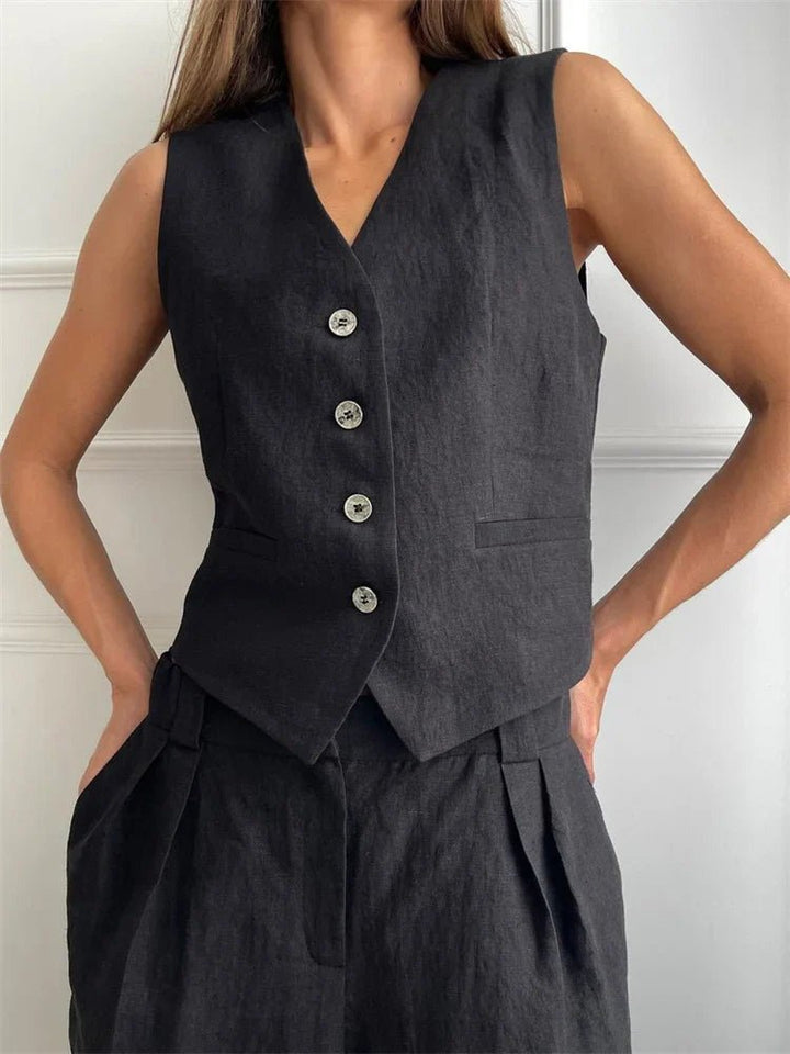 Close-up of the black tailored button-front vest and trousers set