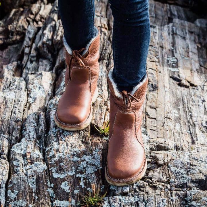 Interior view of winter boots displaying thick cushioned insoles for comfort