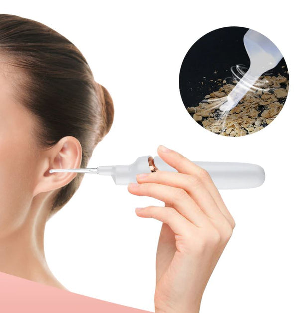 Person holding the white ClearTone electric ear hygiene tool near the ear