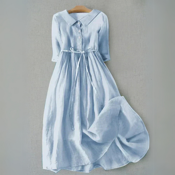 Light blue button-front tie waist flowy midi dress displayed on a hanger