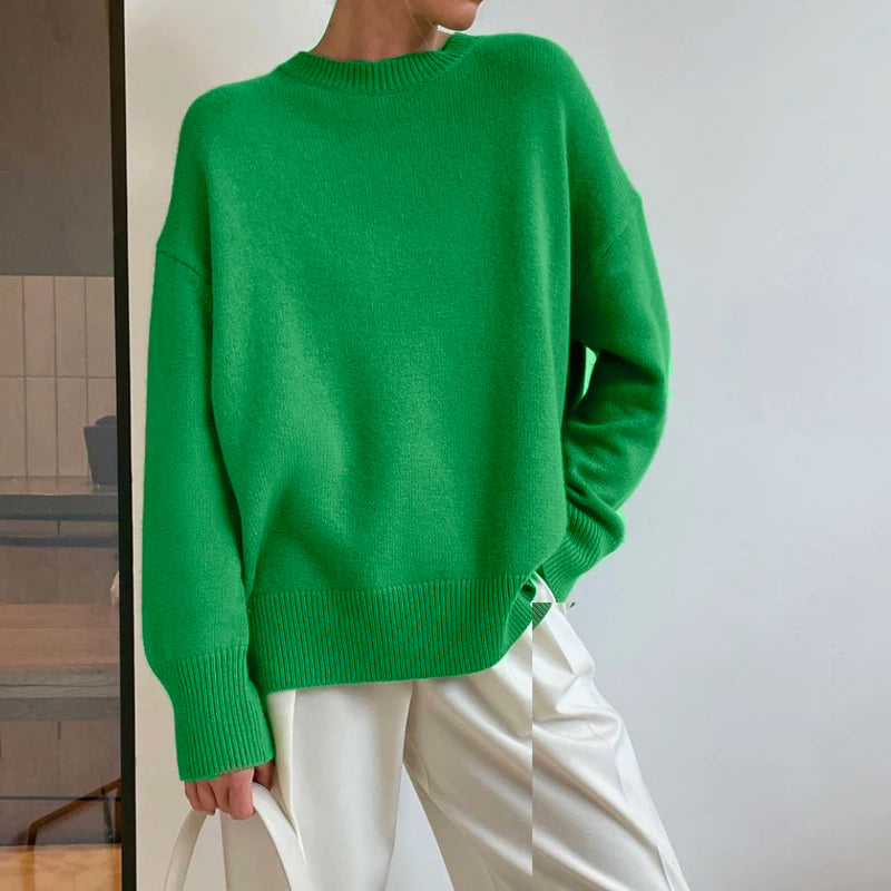 Front view of a woman in a green oversized knit pullover sweater