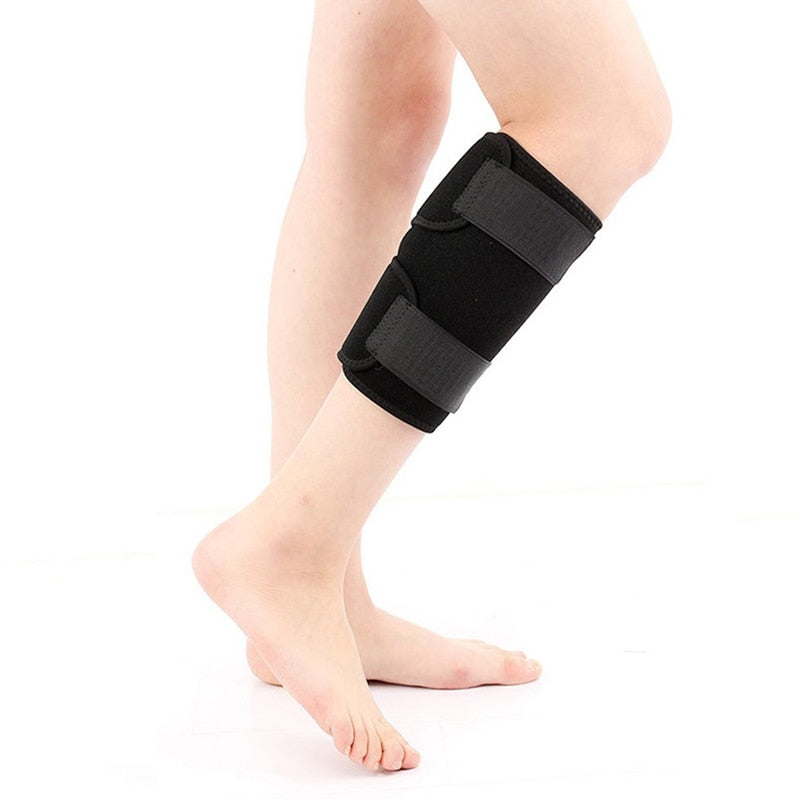 Person wearing black calf compression brace on lower leg