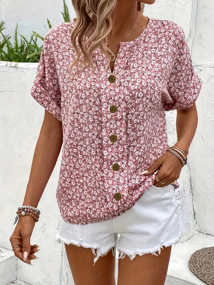 Close-up front view of a pink floral button-detail blouse
