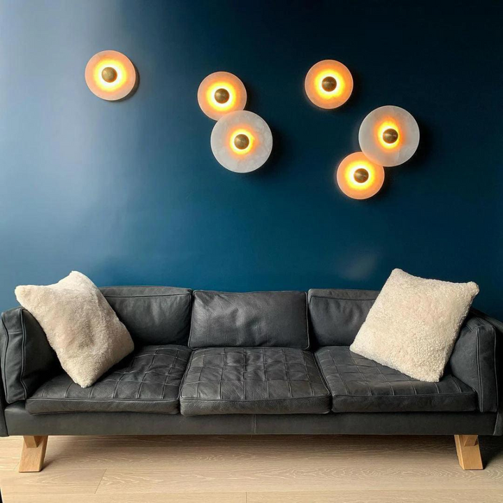 Ambient glow from a luxury alabaster wall lamp in a modern living space