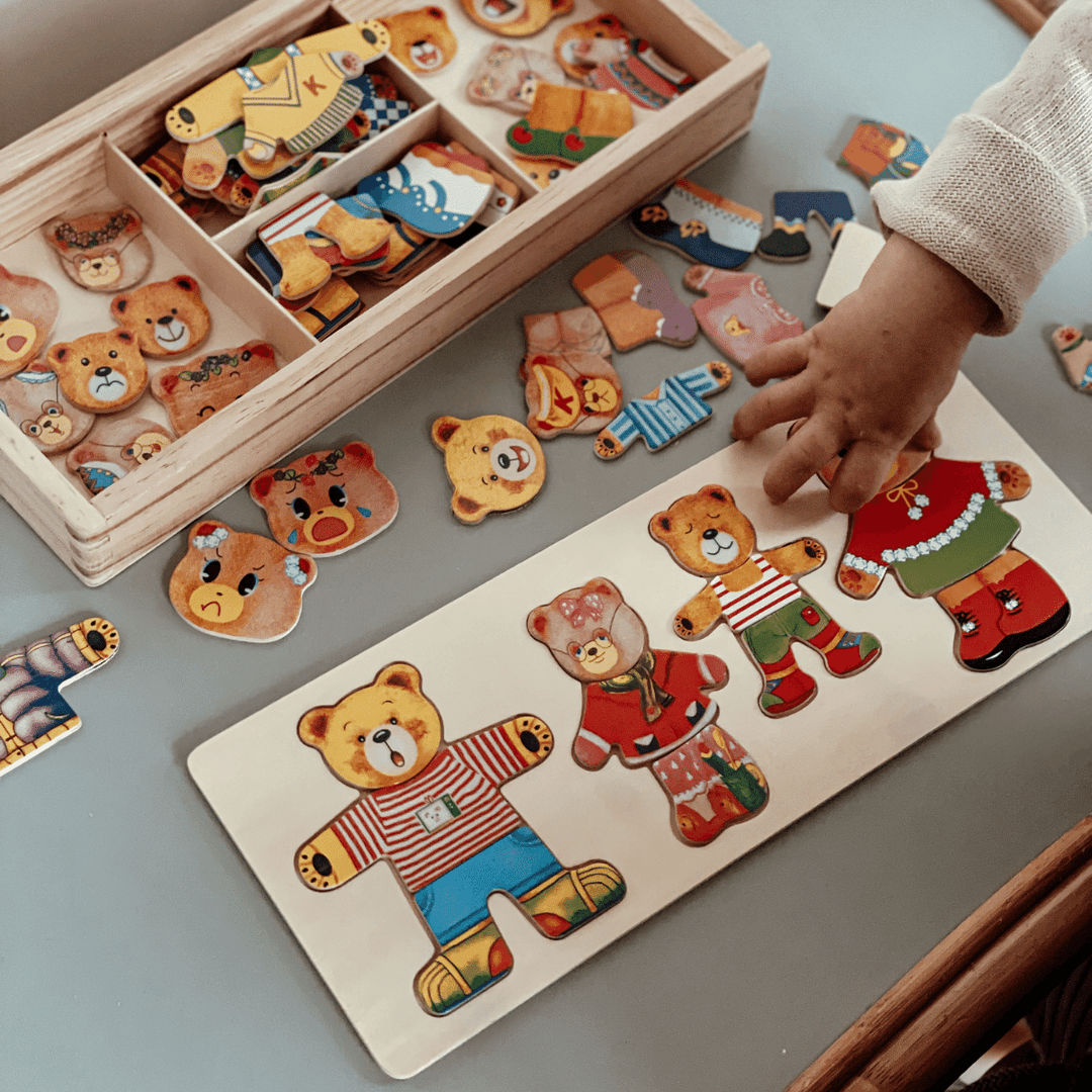 Kids wooden dress-up puzzle toy featuring interchangeable character pieces and outfits.