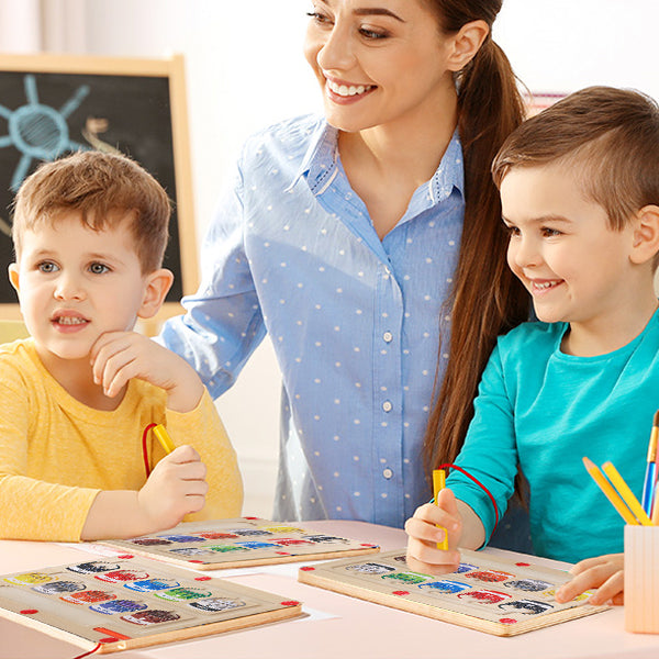 Children and teacher playing together with wooden magnetic maze boards