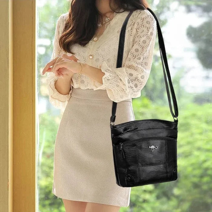 Woman wearing black shoulder bag with skirt and top