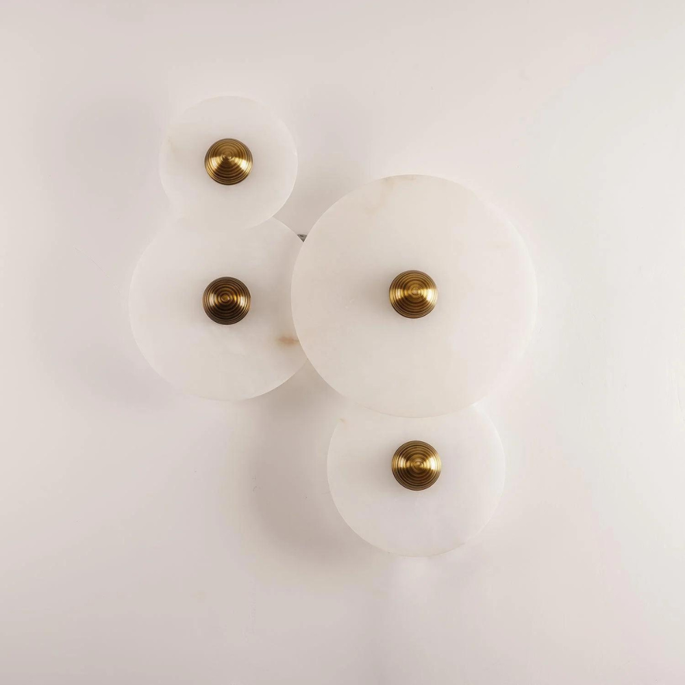 Detailed shot of the mounting bracket and sleek profile of the alabaster sconce