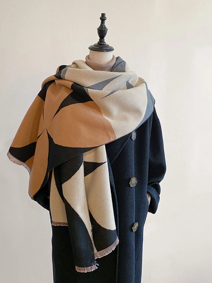 Black and tan patterned reversible soft wrap scarf styled on a coat
