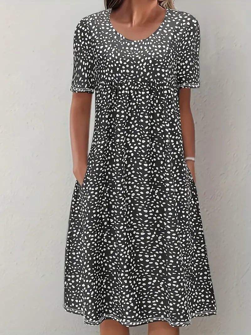Woman wearing black printed short sleeve midi dress with pockets