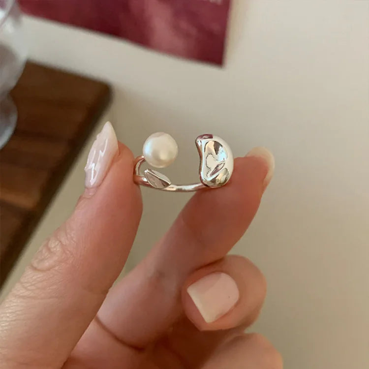 Close up view of the womens adjustable statement ring featuring a pearl and silver bean