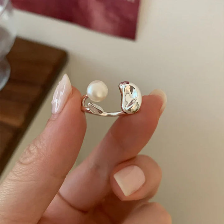 Close up view of the womens adjustable statement ring featuring a pearl and silver bean