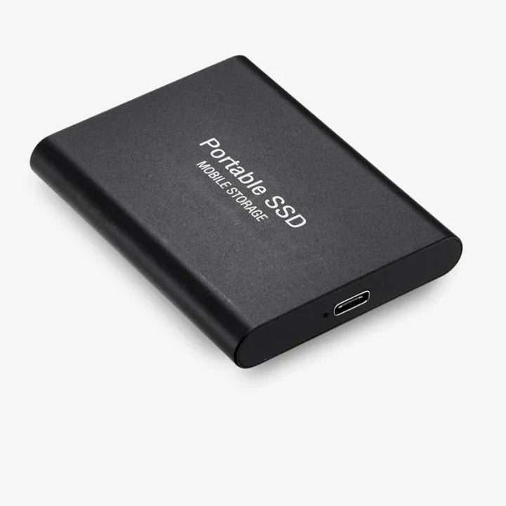 Portable 128GB external solid state drive connected to a laptop for fast data backup