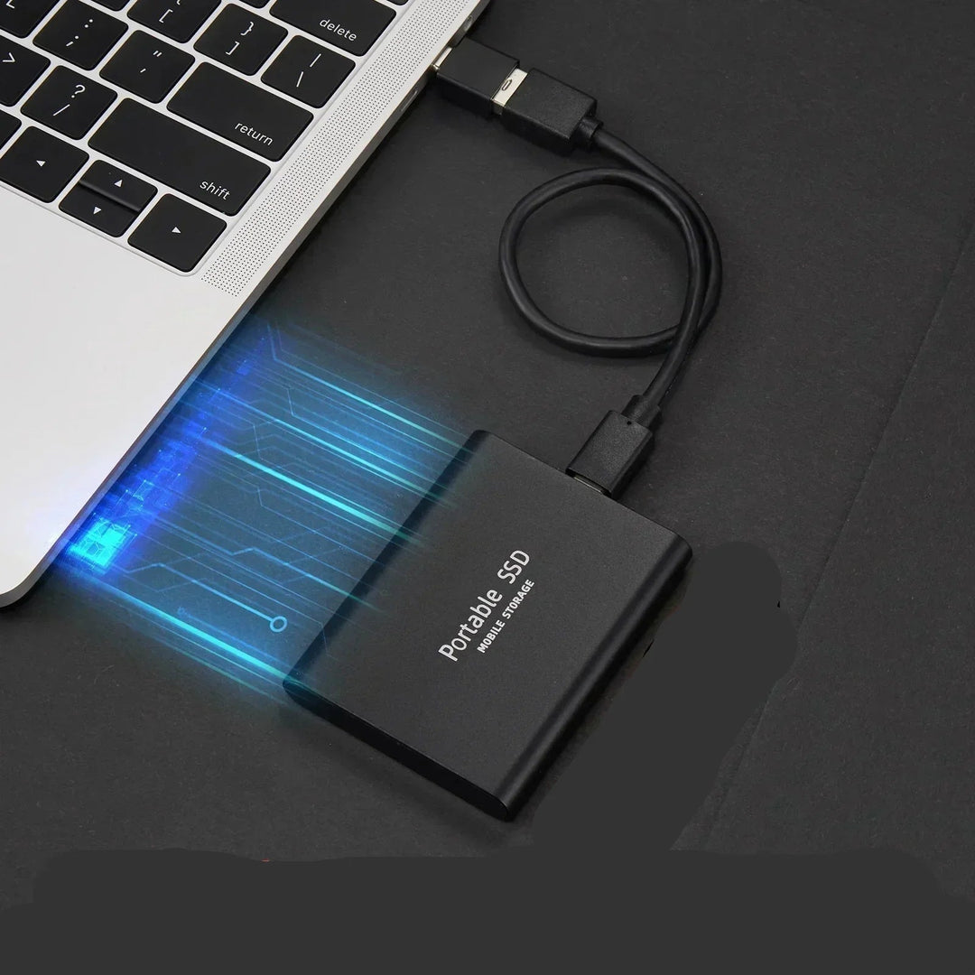 Portable external SSD connected to a laptop via USB cable