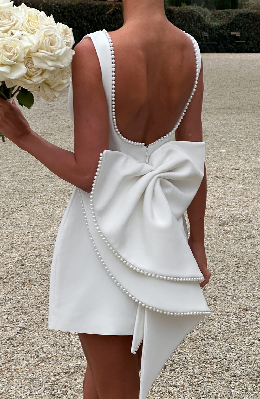 Hanging view of elegant a-line dress with pearl details for special occasions