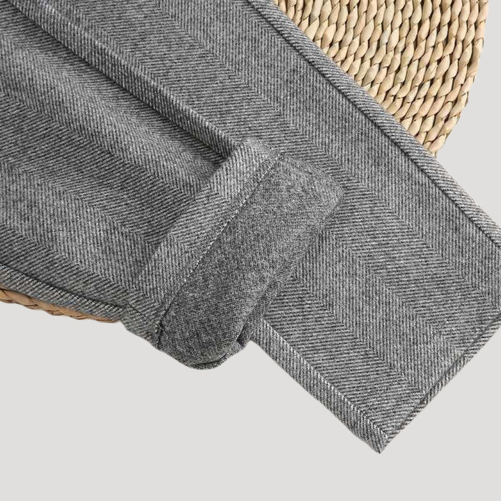 Folded beige men's tailored trousers showcasing versatile fashion and design