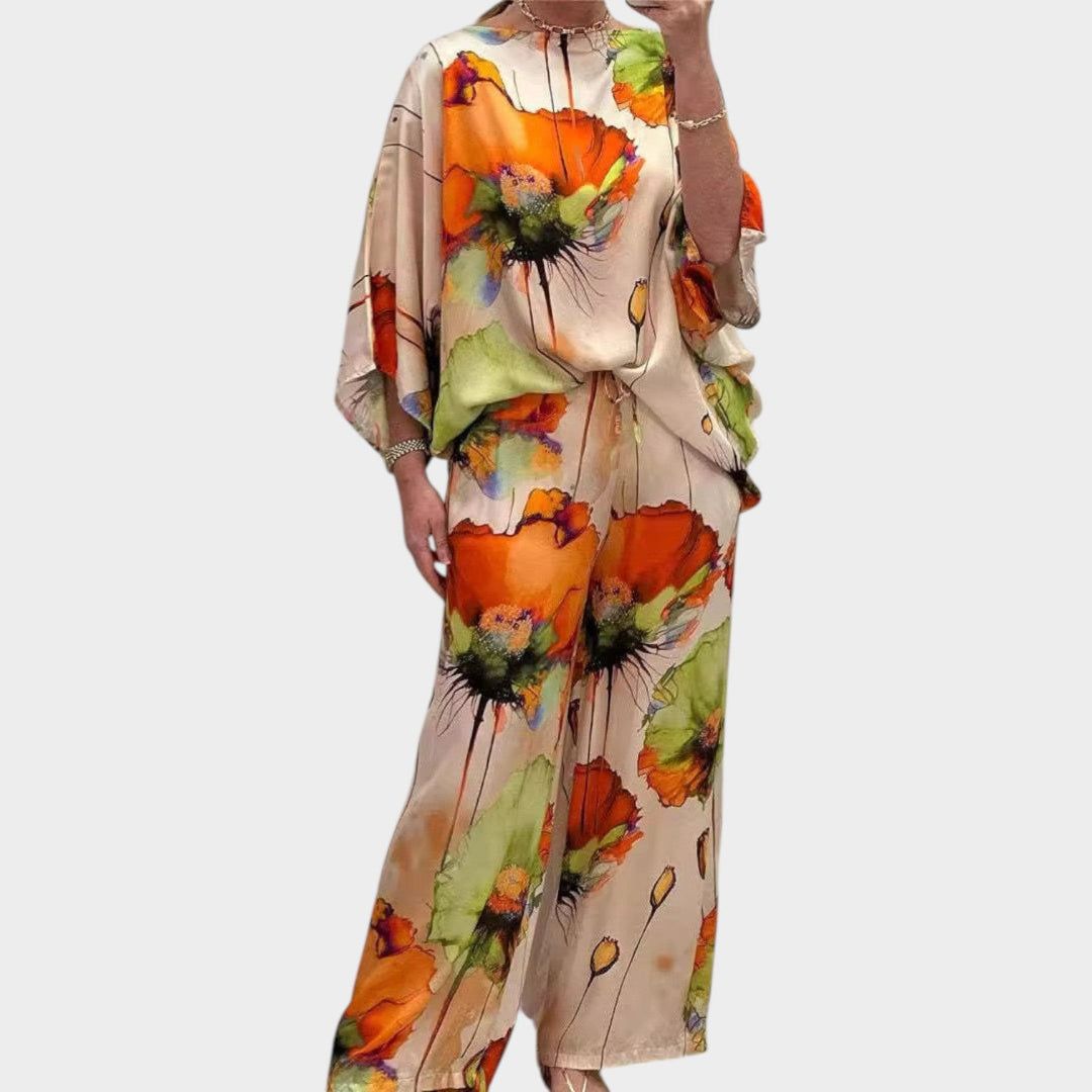 Woman wearing orange floral two-piece matching set with wide leg pants