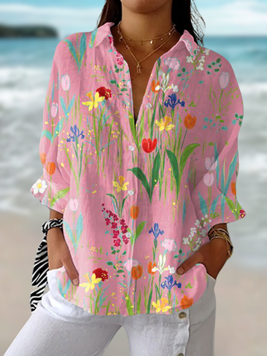 Woman wearing a pink floral spring garden blouse outdoors by the sea