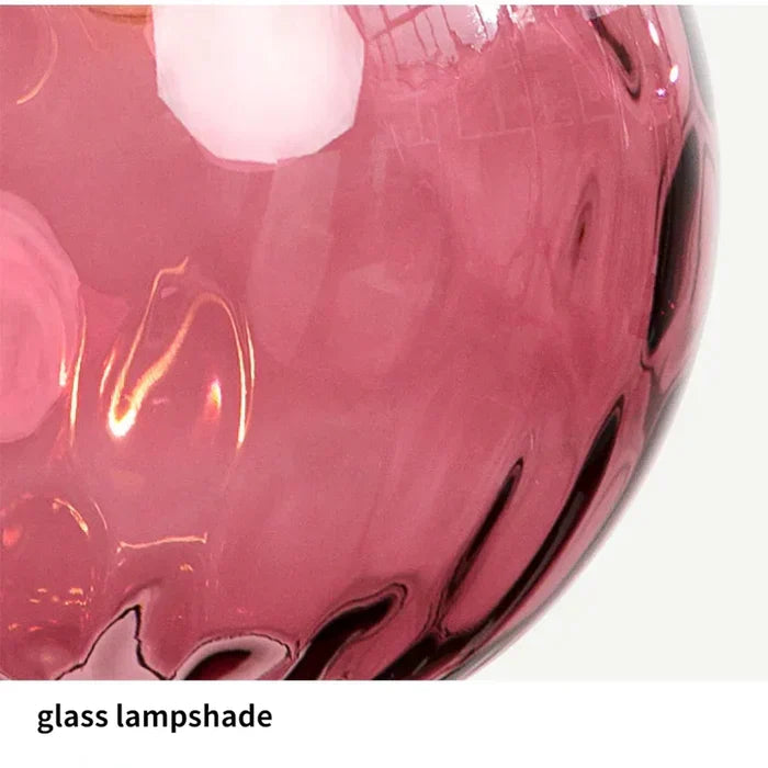 Modern glass globe ceiling lamp illuminating a dining table