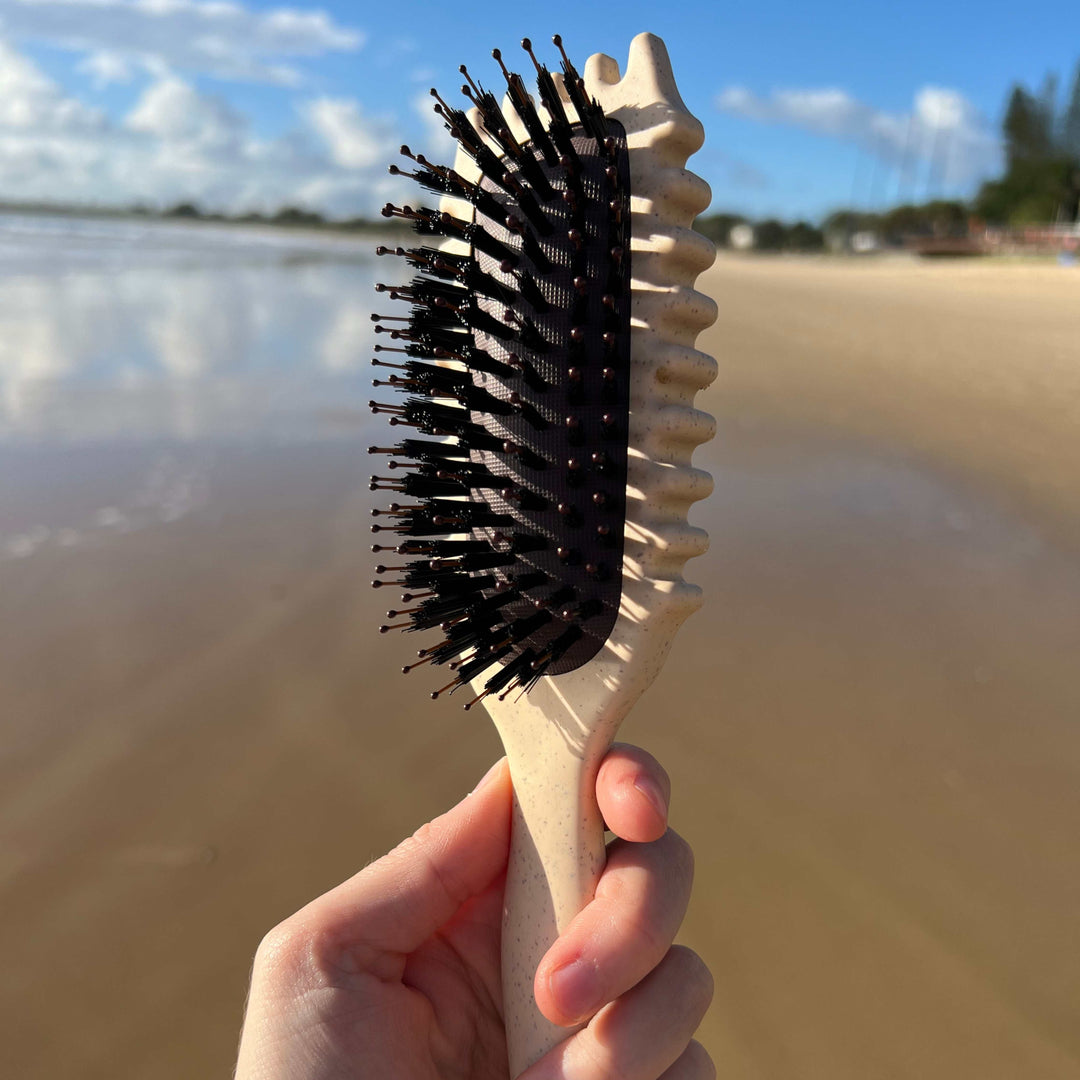 Unisex 3-in-1 curl defining hair brush showing bristles for styling